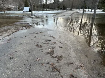 waters flooding over trail on Harrison Park island