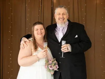 Bride and groom standing beside each other and smiling